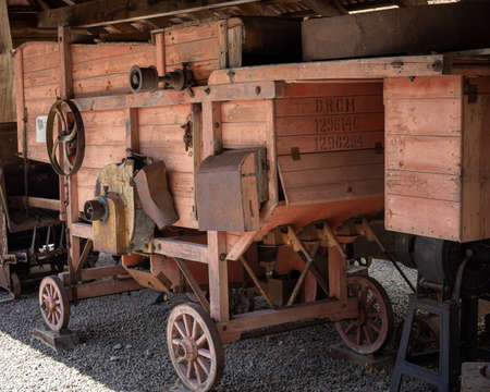 A vintage wooden threshing machine, Wojslawice Arboretum, Poland. 9 July 2021.