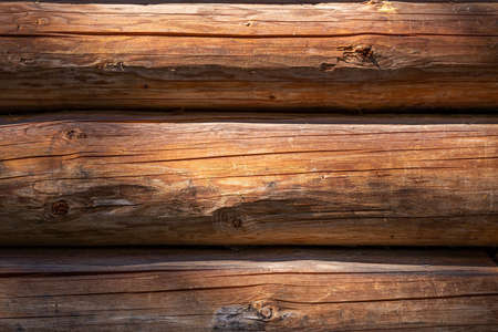 An old cottage wall, made of wooden logs. A background with copyspace.の写真素材