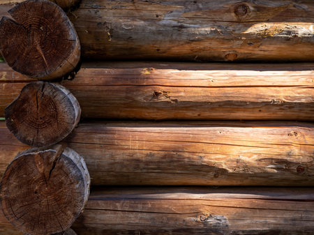 A cottage wall made of horizontal, brown wooden logs. Background with copyspace.の写真素材