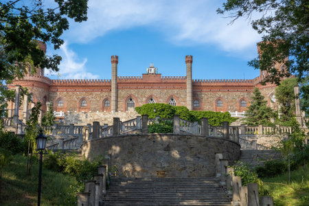 KAMIENIEC ZABKOWICKI, POLAND - July 4, 2021:
Front view and entrance stairs of Kamieniec Zabkowicki Palace. Blue sky, summer day.のeditorial素材