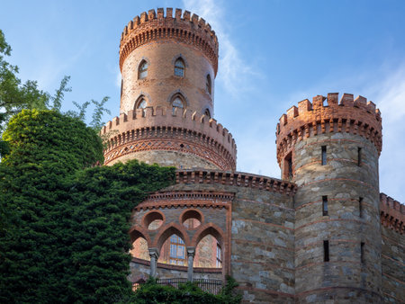 KAMIENIEC ZABKOWICKI, POLAND - July 4, 2021:
Towers of a neo-gothic Kamieniec Zabkowicki Palace. Blue sky, sunny day.のeditorial素材