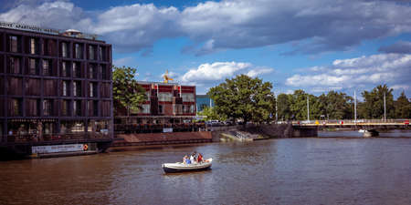 Wroclaw, Poland - August 7, 2021: Group of young people on a boat on Odra River. Modern buildings and a bridge in background.
Sunny day, blue sky.のeditorial素材