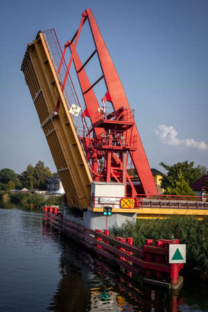 Dziwnow, Poland - September 10, 2021:
An open red drawbridge on Dziwna Channel, entrance for vessels from the sea to the harbour.のeditorial素材