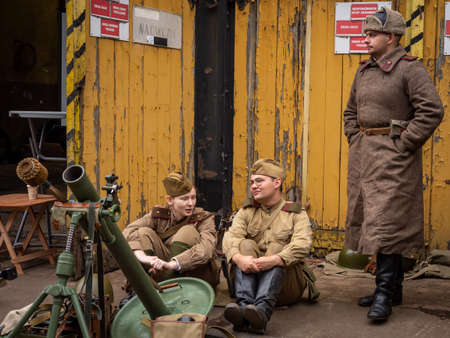 Wroclaw, Poland - September 19, 2021:
Three soviet soldiers dressed in military uniforms, surrounded...