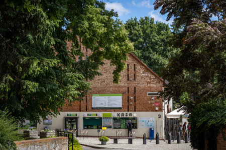 Wojslawice, Poland - July 9, 2021: A man buying an entrance ticket at the ticket office of Wojslawice Botanical Garden. Sunny, summer day.のeditorial素材