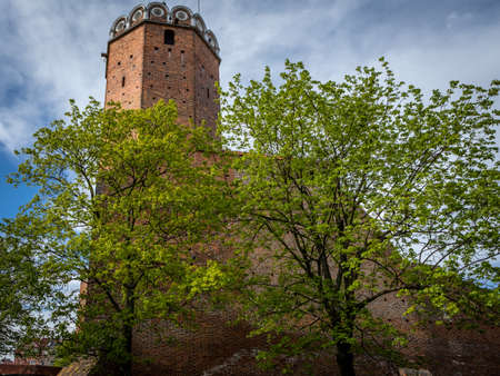 Leczyca, Poland - May 10, 2021: A medieval royal castle, surrounded with green trees. Sunny spring day. No people.のeditorial素材