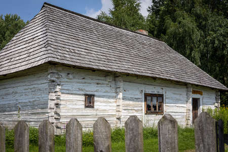 Kakonin, Poland - July 28, 2021: An old, white cottage at Chata Kaka restaurant, surrounded with a wooden fence.のeditorial素材