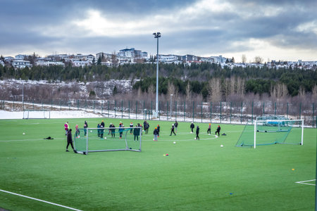 Reykjavik, Iceland - January 20, 2022: A group of school kids training on the football pitch on a...