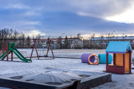 Reykjavik, Iceland - January 20, 2022: An empty kids playground covered with snow. Winter day, no...