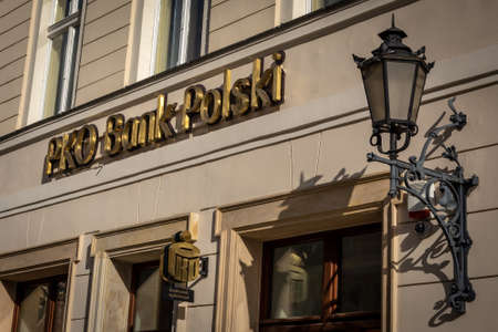 Wroclaw, Poland - February 19, 2022: Facade of PKO Polish Bank building in the old market square. Bank name golden letters on the wall.のeditorial素材