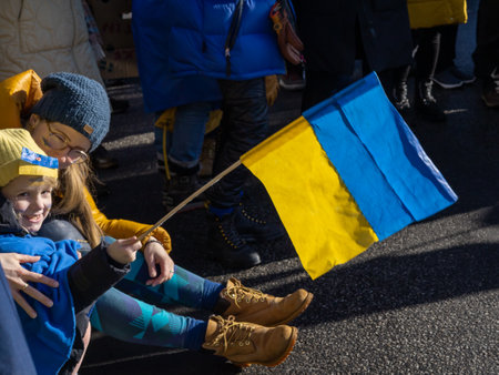 Reykjavik, Iceland - March 13, 2022: Mother with child protesting against war in Ukraine at a peaceful demonstration in front of Russian embassy in Reykjavik.のeditorial素材