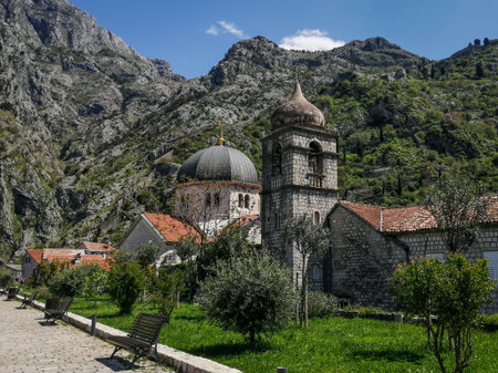 Kotor, Montenegro - April 29, 2022: A view to Saint Nicolas church in Kotor Old town. Rocky mountains in background.のeditorial素材