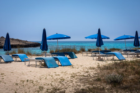 Sunbeds and umbrellas on the sandy beach on the island of Crete, Greeceの写真素材