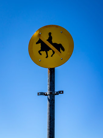 Traffic sign on a blue sky background with a silhouetteの写真素材