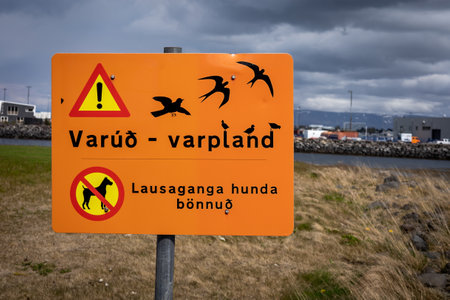 Warning sign with a flock of birdsの写真素材