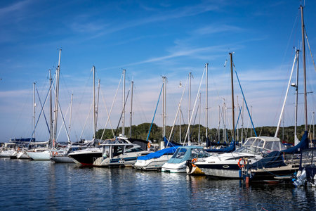 Kamien Pomorski, Poland - September 14, 2023: Boats moored along the quay in Kamien Lagoon (Zalew Kamienski).のeditorial素材