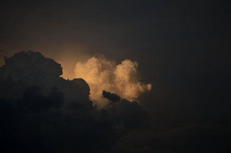 Dark clouds, clouds on in the dark sky. Stormy weather, sun shining through the clouds.