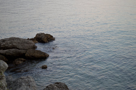 Rocks at the beach, calm water, small waves, clear water.