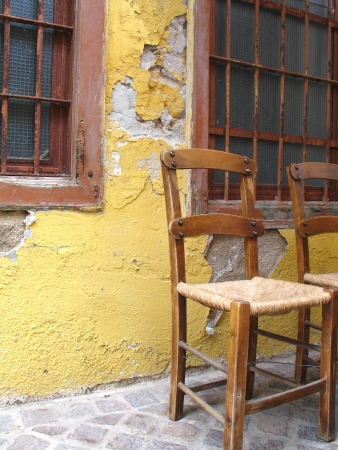Two brown chairs and colored wall in greek cityの写真素材
