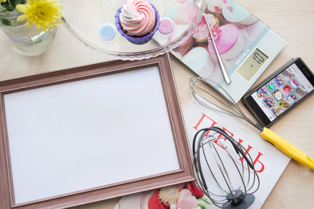 frame with a white sheet of paper lies on the table bleached oak, lying around objects: kitchen...