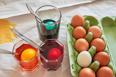 preparation for the Easter holiday, coloring eggs at home, tissue with spoons, Shot of colorful Easter eggsの写真素材