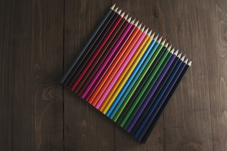 Colour pencils on wooden texture backgroundの写真素材