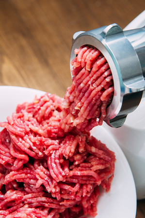 Meat grinder - process of grinding meat. Beef red mince in mincing-machine.
の写真素材