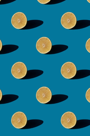 Grapefruit pattern on a blue background. Minimal concept with hard light shadows.の写真素材