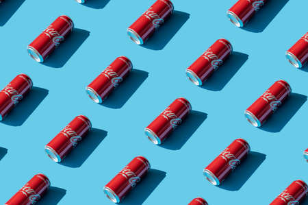 Krakow, Poland - 13 May 2021. Pattern of Coca-Cola on blue background. Classic Coca-Cola can isolated Original taste.のeditorial素材