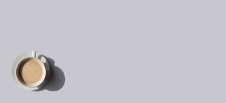 White cup of coffee on gray background with place for text. Minimal conceptの写真素材