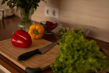 A wooden kitchen counter with fresh vegetablesの写真素材