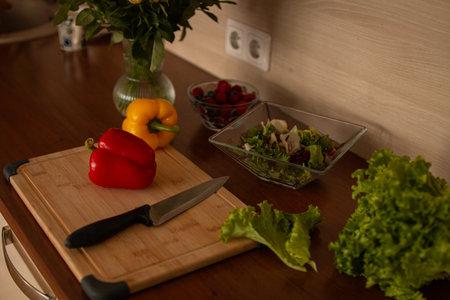 A wooden kitchen counter with fresh vegetablesの写真素材