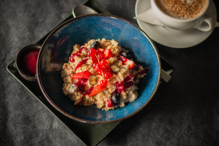 A vibrant oatmeal bowl topped with fresh strawberries, blueberriesの写真素材