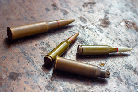 Weapon bullets on rusty metal background. Military industry, war, global arms trade and crime...