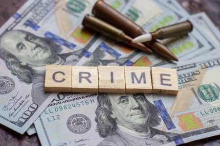 Criminal sign on usa dollars background. Black market, contract killing, robbery, mafia and crime concept.の写真素材