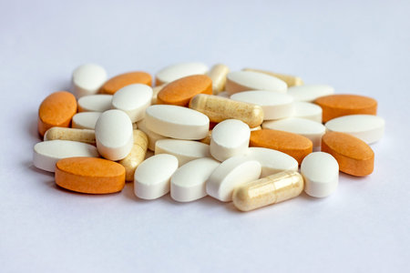Many different pharmaceutical medicine pills, tablets and capsules on white background. Pharmacy...
