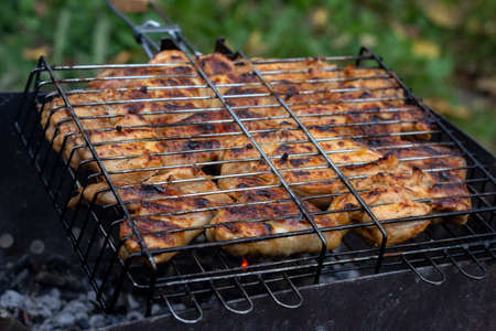 Roasted chicken meat on the grill cooking on the coals.の写真素材