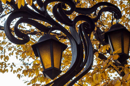Old vintage city street lantern on blue cloudy sky background in the public place.の写真素材