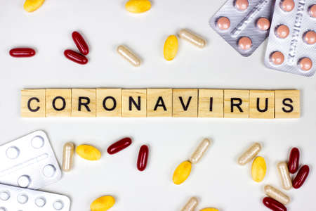 The medical phrase coronavirus with pills, capsules and tablets on light background. Ncov epidemic alert concept.の写真素材