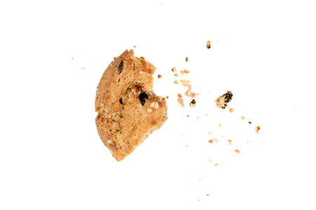 Close up of chocolate chip cookie pieces with crumbs isolated on white background.の写真素材
