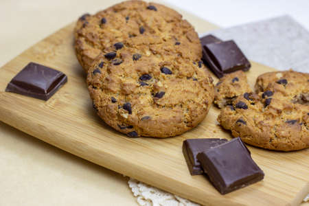 Freshly baked American chocolate chip cookies on rustic brown wooden table background.の写真素材