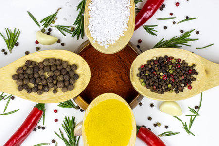 Top view of variety of spices and seasonings (indian curry, different pepper, paprika powder, salt,...