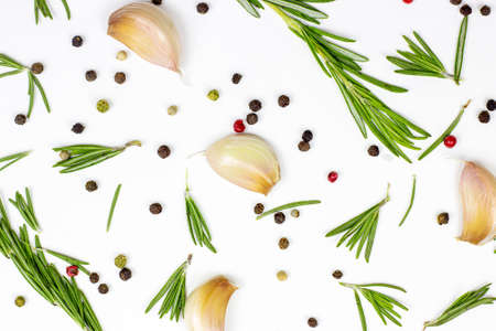 Top view of summer spices: garlic, green rosemary and peppercorns on white table background.の写真素材