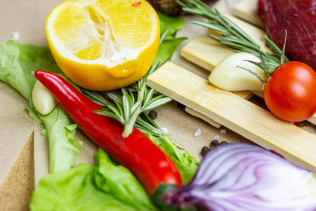 Summer vegetables (onion, garlic, tomato, pepper, rosemary and lemon) and champignon mushroom on...