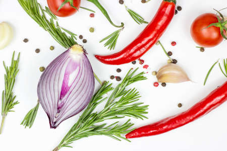 Top view of summer vegetables: onion, garlic, tomato, red pepper, rosemary and peppercorns on white table background.の写真素材