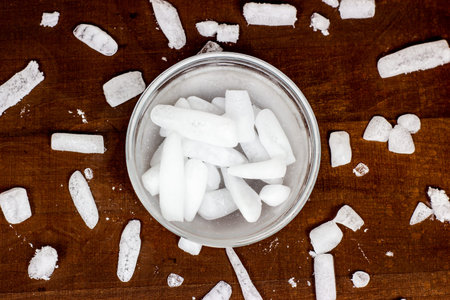 Top view of white cool dry ice (frozen carbon dioxide) with smoke effect in the glass bowl on the...