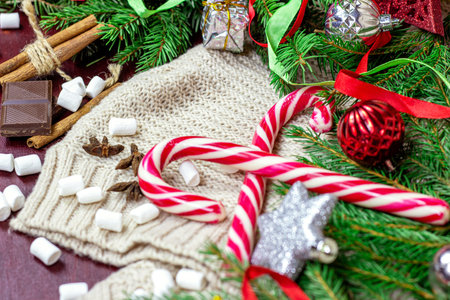 Bright Christmas and New Year celebration background with fir tree branches, holiday decorations and...