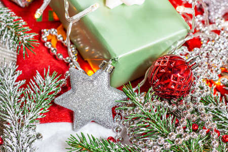 Bright Christmas and New Year holiday decorations with fir tree and lights on red background.の写真素材