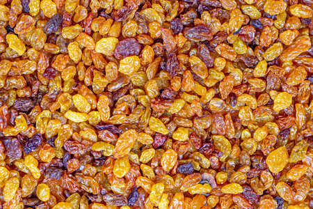 Brown raisins (dried yellow grape) texture as a food background.の写真素材