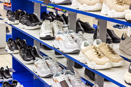 MINSK, BELARUS - MARCH 22, 2021: New sport footwear on the retail clothing shop display shelf.のeditorial素材